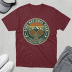 Maroon t-shirt with "Dink National Park Outdoor Heritage Adventure Awaits" logo.