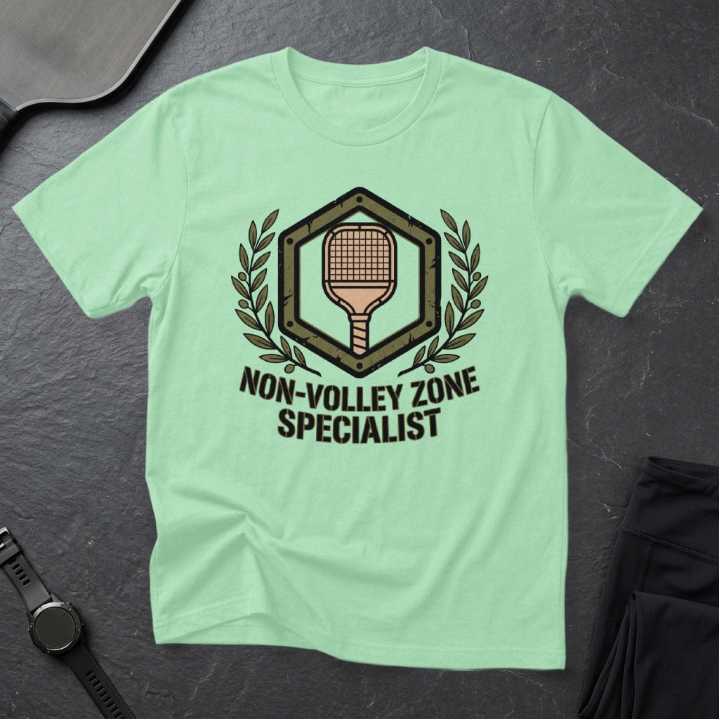 Light green t-shirt with "Non-Volley Zone Specialist" design and pickleball paddle graphic.