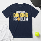 Navy t-shirt with "I MIGHT HAVE A DINKING PROBLEM" and pickleball graphic.