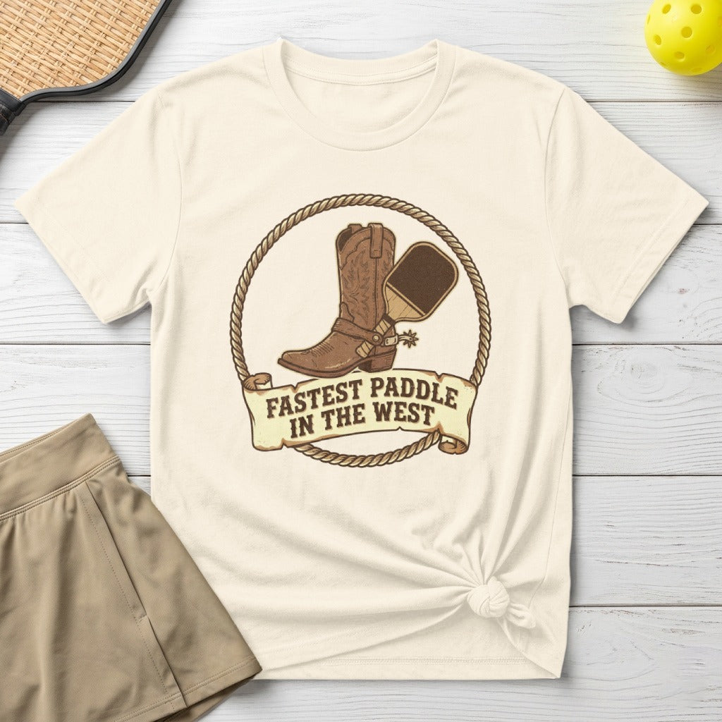 Cowboy boot and pickleball paddle on a cream t-shirt with text "Fastest Paddle In The West".