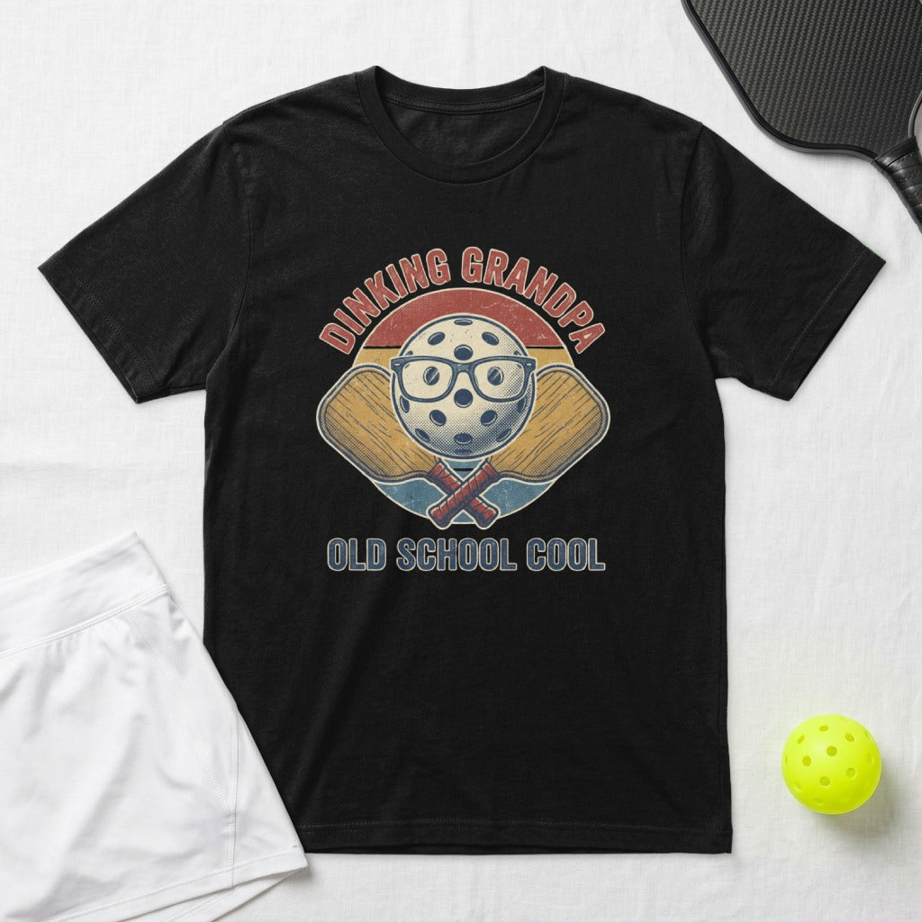 Black t-shirt with pickleball graphic and "Dinking Grandpa Old School Cool" text.