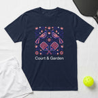 Navy t-shirt with floral birds and pickleball paddles, text "COURT & GARDEN".
