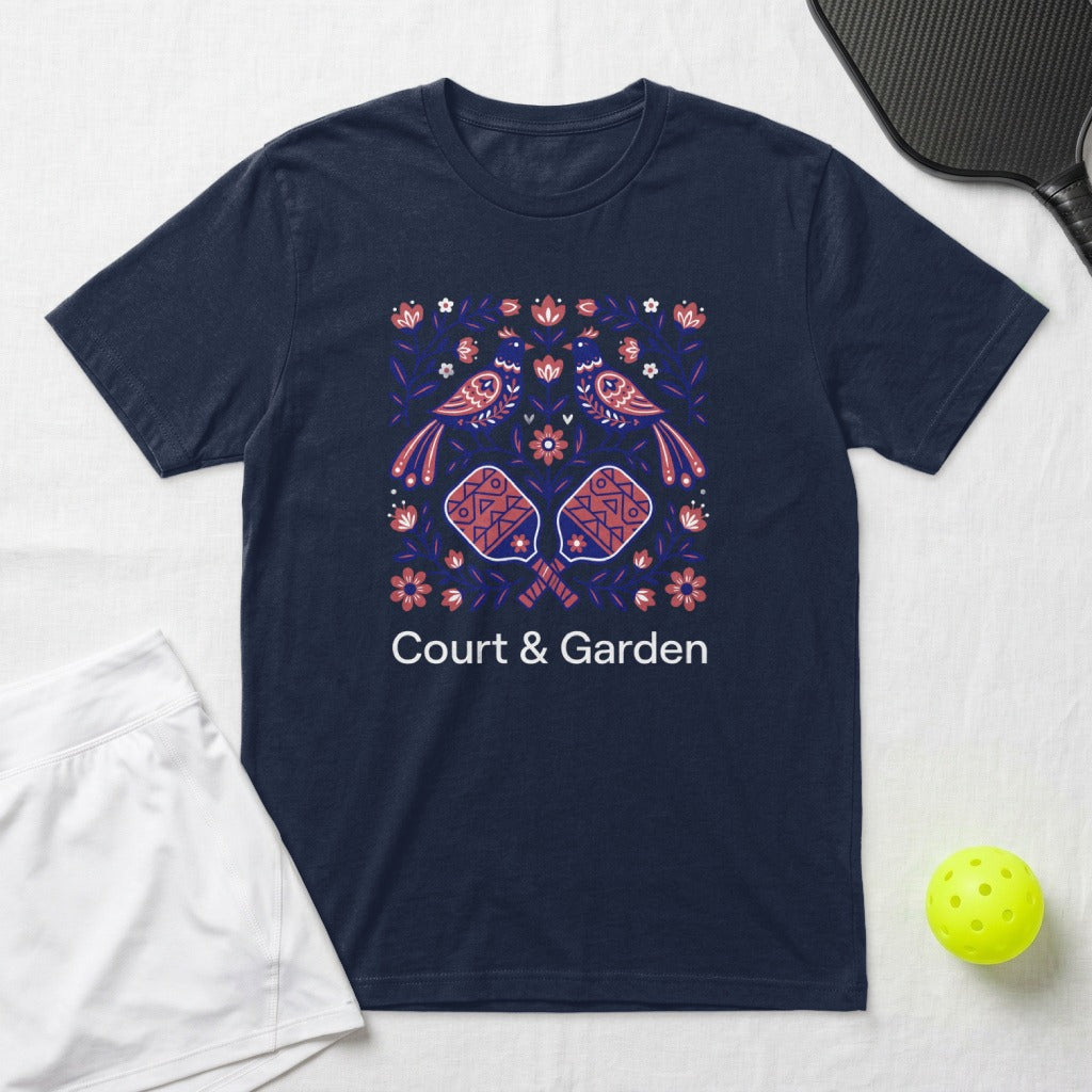 Navy t-shirt with floral birds and pickleball paddles, text "COURT & GARDEN".
