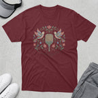 Maroon t-shirt with embroidered birds, flowers, and a paddle.