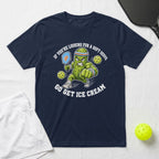 Cartoon pickle wearing a headband and wristbands playing pickleball, text: IF YOU'RE LOOKING FOR A SOFT SERVE GO GET ICE CREAM