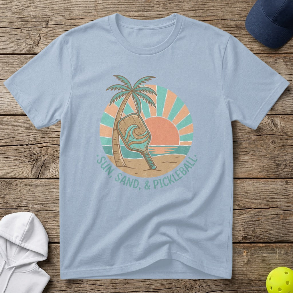 Light blue t-shirt with "Sun, Sand, & Pickleball" graphic and a pickleball paddle.
