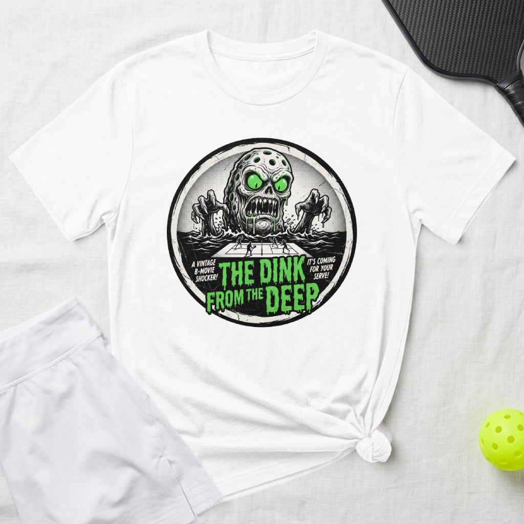 T-shirt graphic with a monster from the deep, pickleball nets, and text.