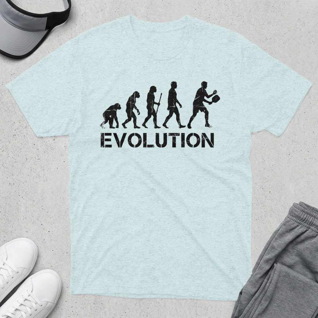 T-shirt with "EVOLUTION" text and silhouettes depicting human evolution to pickleball player.