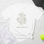 White t-shirt with a line drawing of pickleball balls on a vine and text "grown on the court."