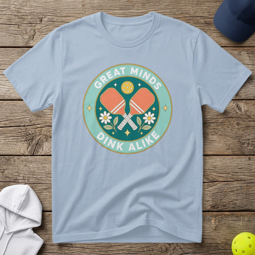 Light blue t-shirt with "Great Minds Dink Alike" and pickleball paddles graphic.