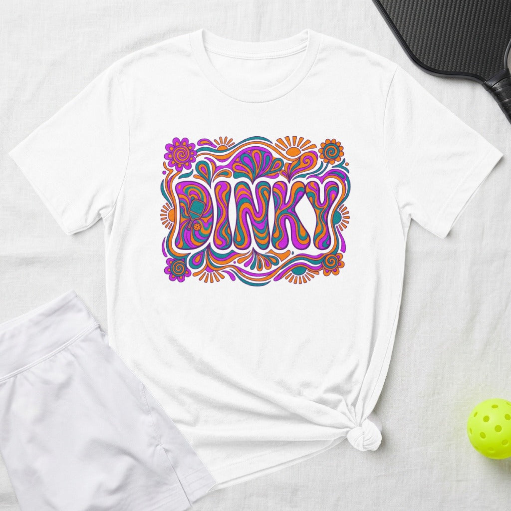 White t-shirt with "DINKY" in colorful, psychedelic lettering and playful floral accents.