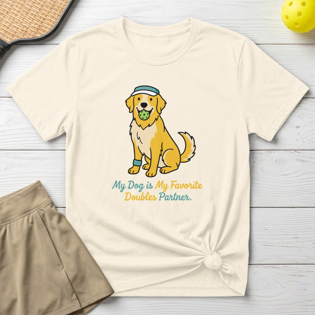 Golden retriever wearing a visor, holding a tennis ball, with text "My Dog Is My Favorite Doubles Partner."