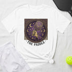 White t-shirt with a celestial pickleball paddle design and "The Paddle" text.