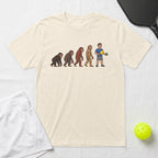 T-shirt with evolution of man graphic holding pickleball paddle and ball.