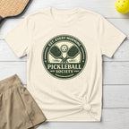 Pickleball Society emblem with paddles and text on a cream t-shirt.