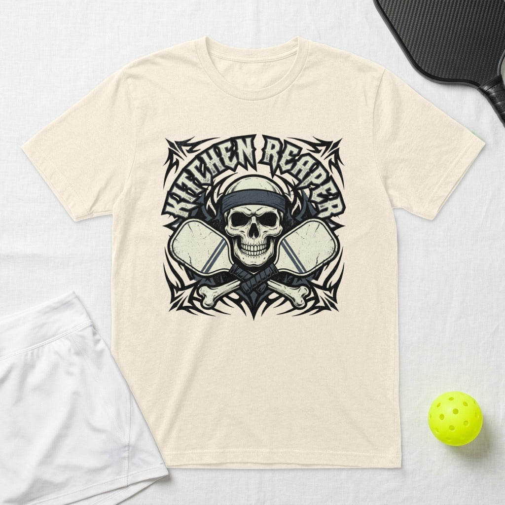"Kitchen Reaper" skull logo with crossed pickleball paddles on a cream t-shirt.