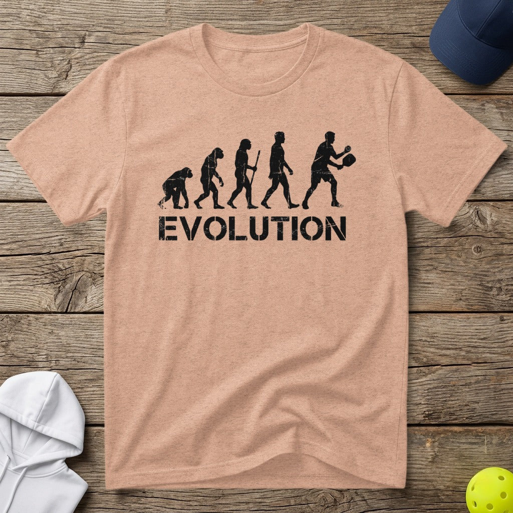 T-shirt with distressed graphic of human evolution progressing to playing pickleball.