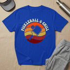 Blue t-shirt with "Pickleball & Chill" retro sunset graphic.