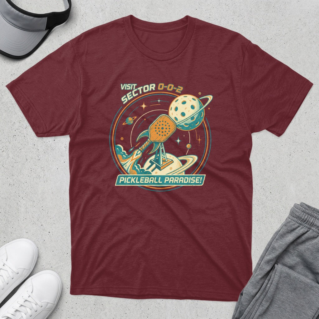 Maroon t-shirt with "Visit Sector 0-0-2 Pickleball Paradise!" text and space-themed pickleball graphic.