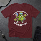 Maroon t-shirt with cartoon pickle playing pickleball and text "GO GET ICE CREAM".