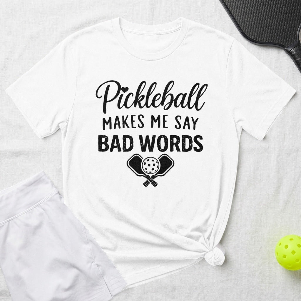White t-shirt with "Pickleball Makes Me Say Bad Words" and pickleball paddles graphic.
