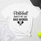 White t-shirt with "Pickleball Makes Me Say Bad Words" and pickleball paddles graphic.