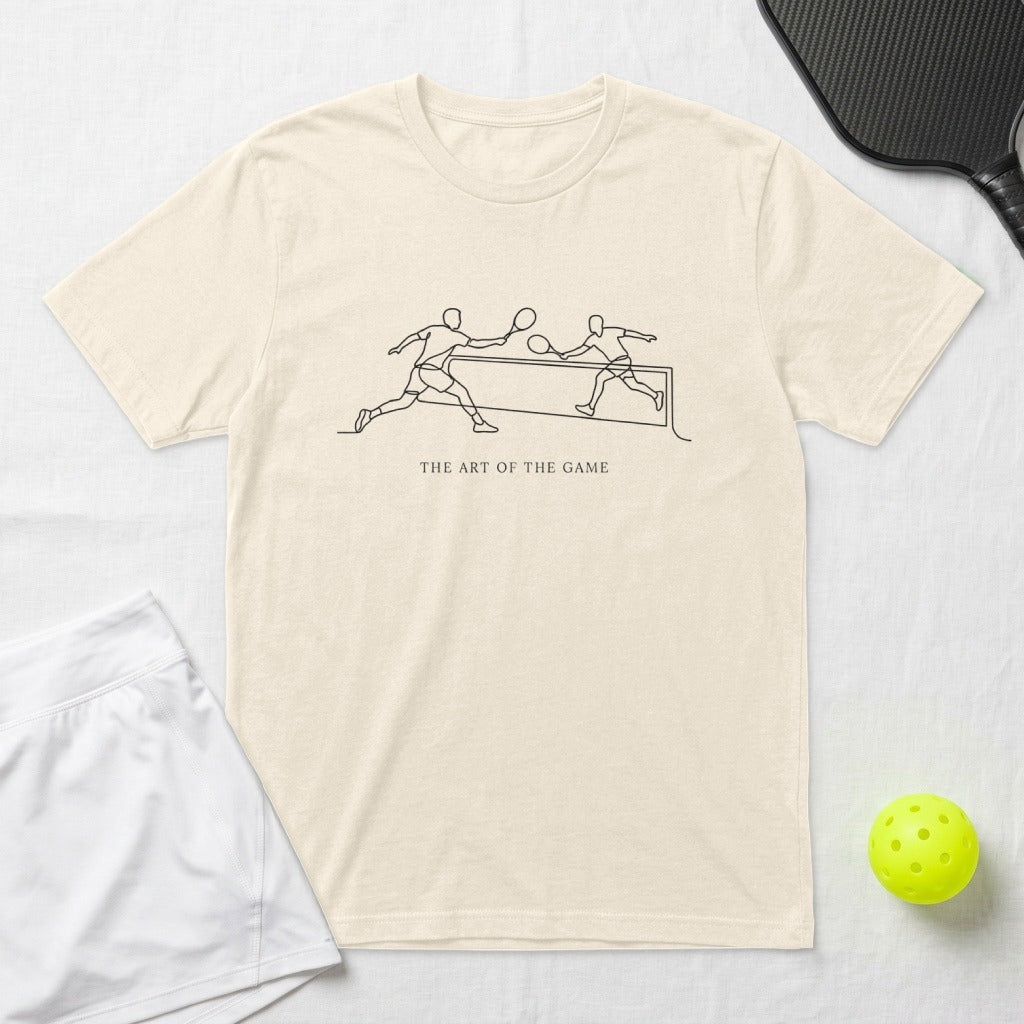 Cream t-shirt with line art of pickleball players and text "THE ART OF THE GAME".