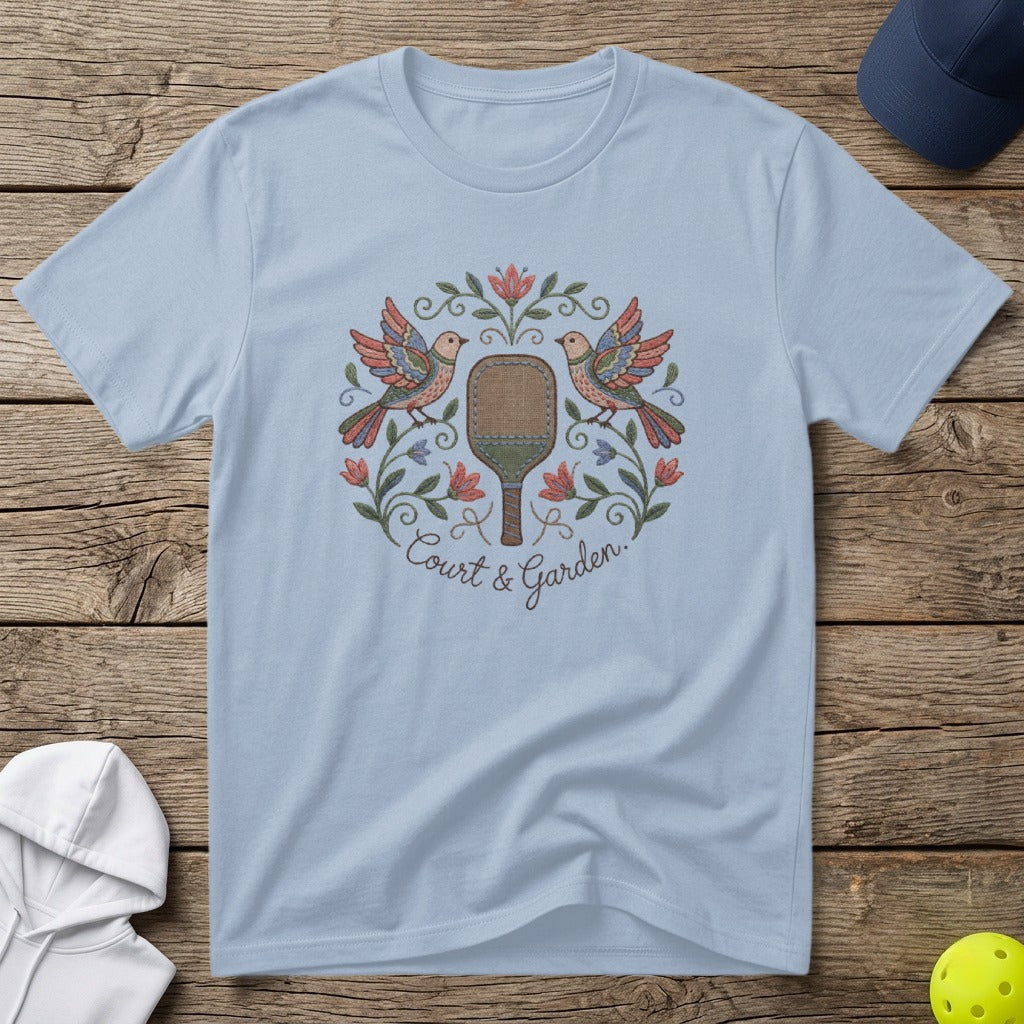 Light blue t-shirt with embroidered pickleball paddle and birds design.