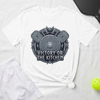 White t-shirt with shield and axe design reading "Victory or the Kitchen".