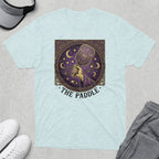 Celestial pickleball paddle design with stars and moons on a light blue t-shirt.