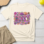 Cream t-shirt with colorful "DINKY" text in a groovy, psychedelic font.