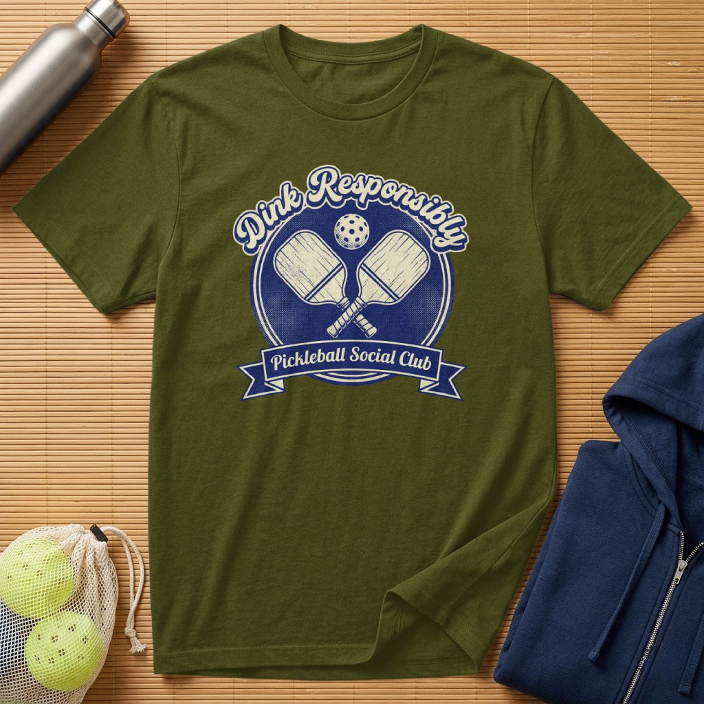 Olive green t-shirt with "Dink Responsibly Pickleball Social Club" text and crossed paddles.