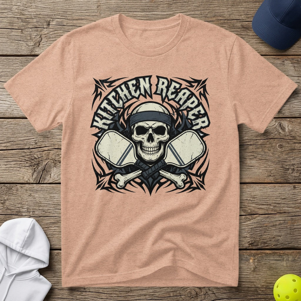 Peach t-shirt with skull, crossed pickleball paddles, and "Kitchen Reaper" text.