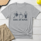 Gray t-shirt with pickleball, coffee cup, and beer mug icons and text "SERVE. SIP. REPEAT."