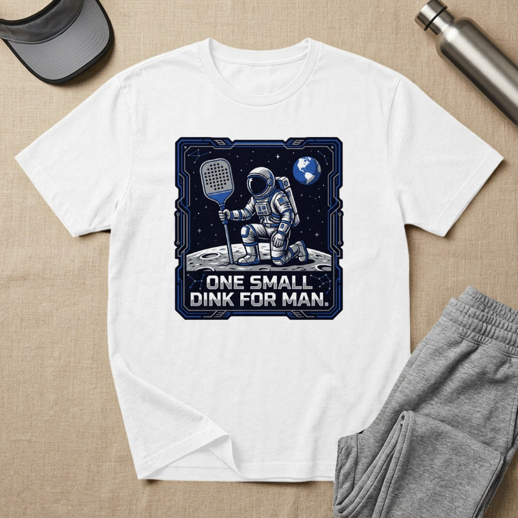 T-shirt graphic: astronaut on moon with paddle, text "ONE SMALL DINK FOR MAN."