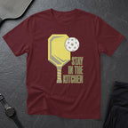 Maroon t-shirt with pickleball paddle, ball, and text "Stay In The Kitchen".