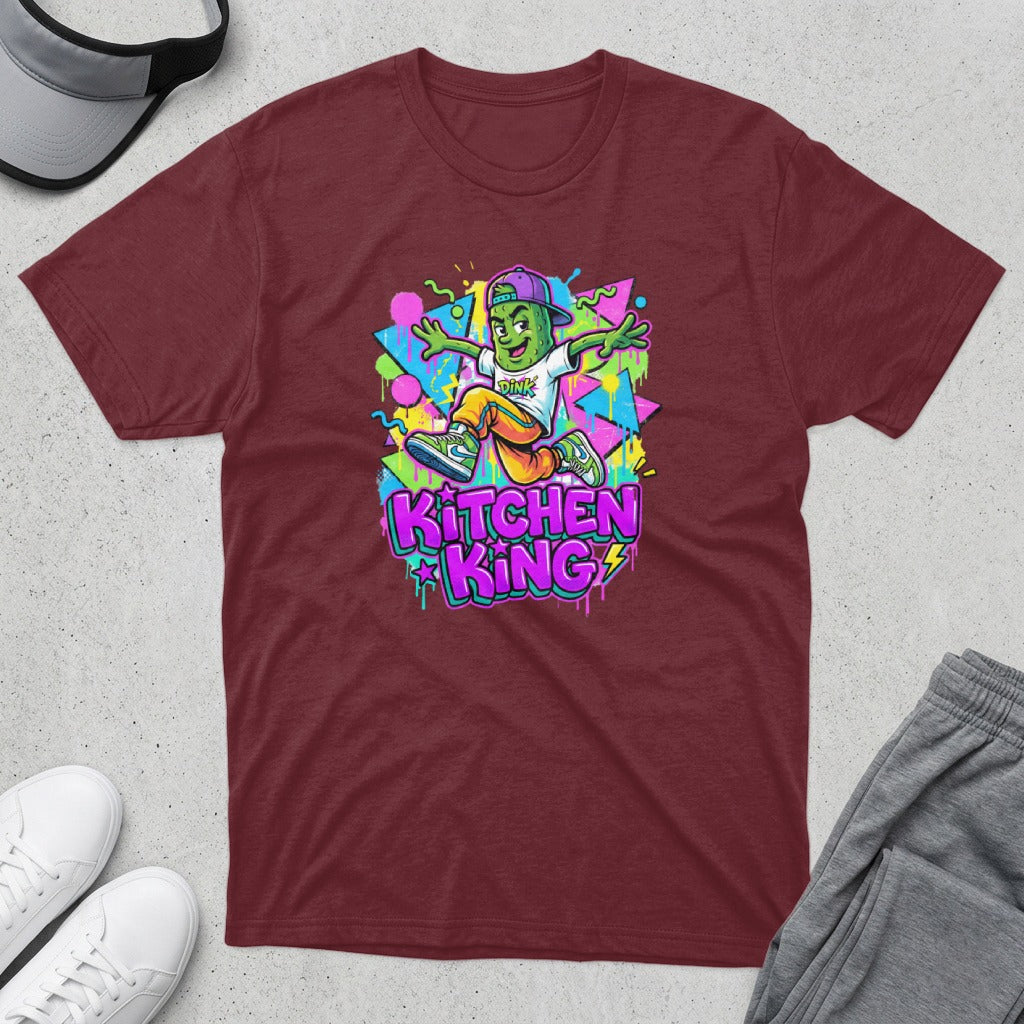 Maroon t-shirt with a cartoon character wearing a hat and jumping.