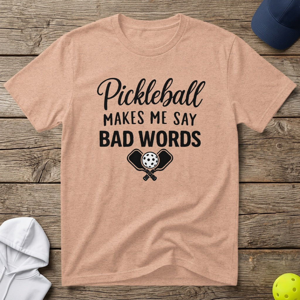 Peach t-shirt with black text: "Pickleball makes me say bad words" and crossed paddles.