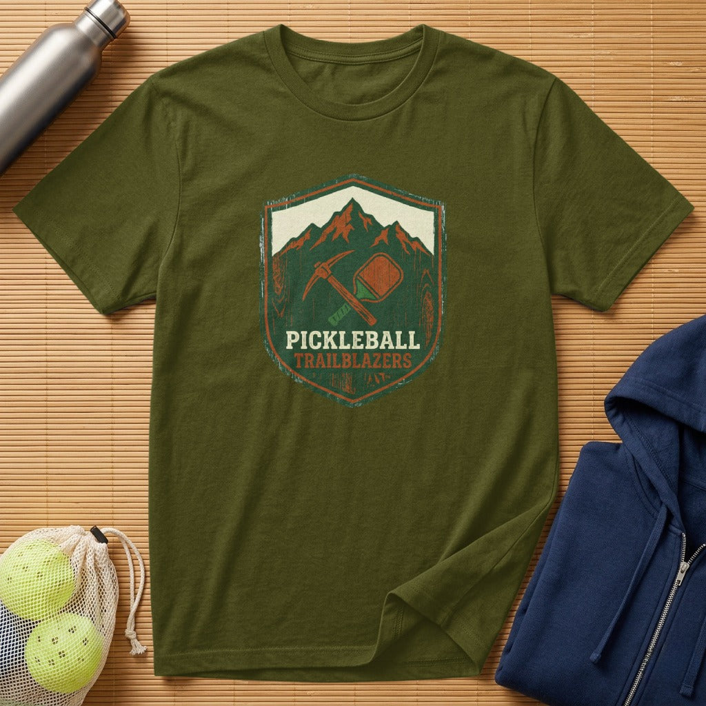 Olive green t-shirt with a mountain and pickleball paddle logo.