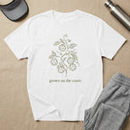White t-shirt with green line art of pickleballs and vine, text "grown on the court".