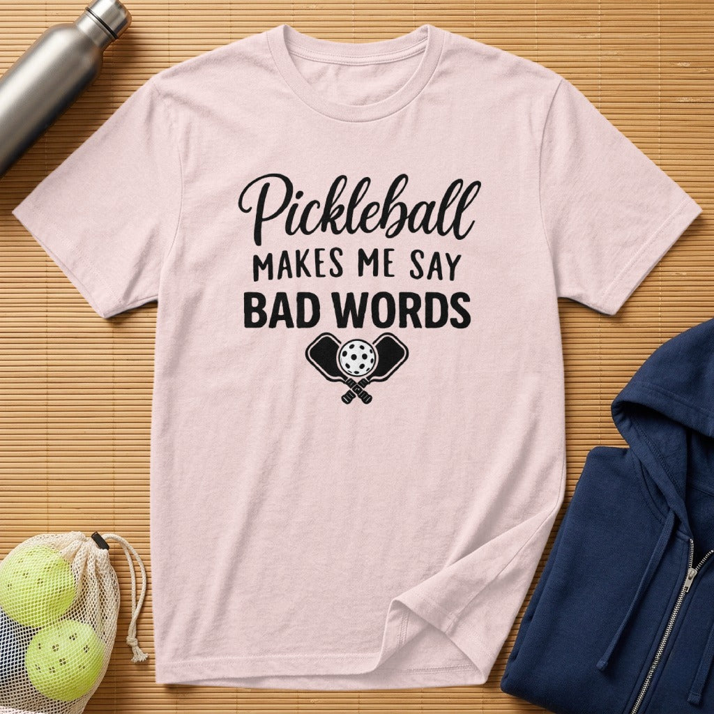 Pink t-shirt with "Pickleball Makes Me Say BAD WORDS" and crossed paddles graphic.
