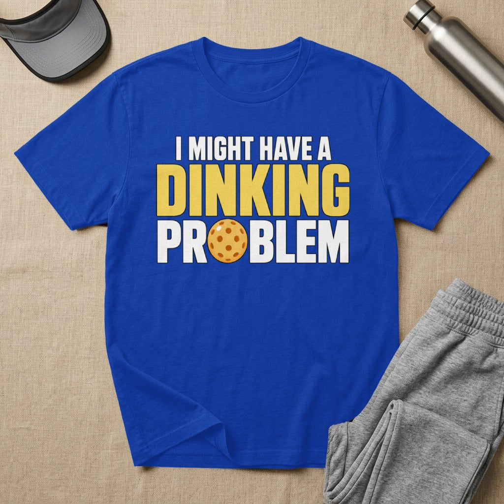 Blue t-shirt with yellow text "I MIGHT HAVE A DINKING PROBLEM" and pickleball graphic.