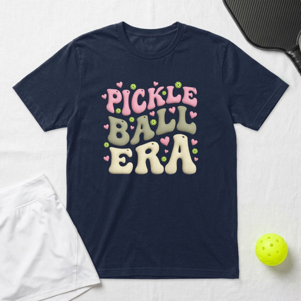 Navy t-shirt with "Pickleball Era" in pink and green retro lettering.