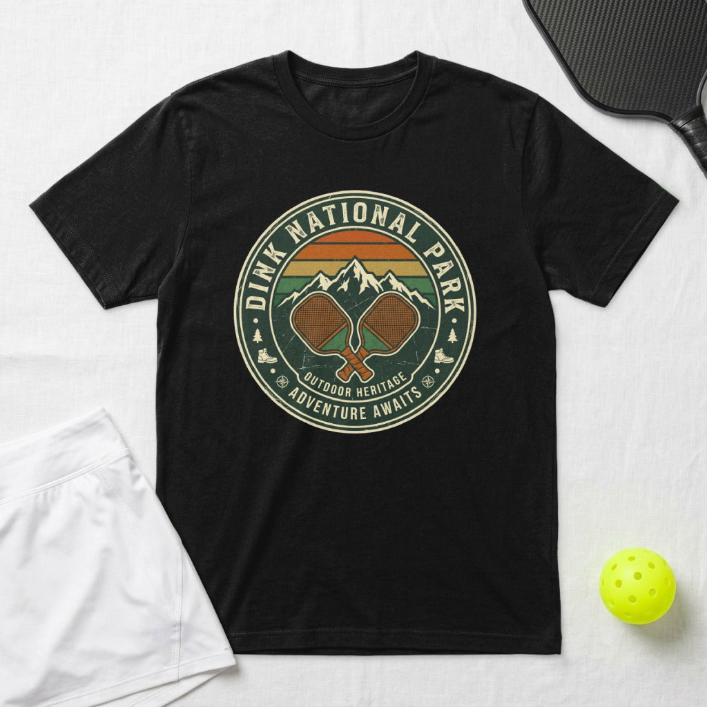 Black t-shirt with "Dink National Park Outdoor Heritage Adventure Awaits" and pickleball paddles graphic.