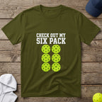Olive t-shirt with "CHECK OUT MY SIX PACK" and six pickleballs.