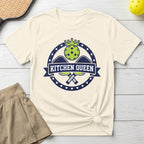 Cream t-shirt with "Kitchen Queen" text and pickleball paddles emblem.