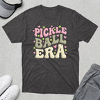 Dark gray t-shirt with "Pickle Ball Era" in colorful bubble letters.