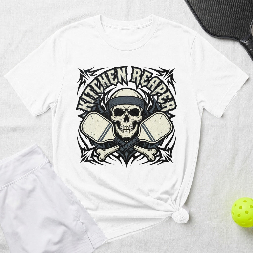 White t-shirt with a skull graphic, crossed pickleball paddles, and tribal designs.