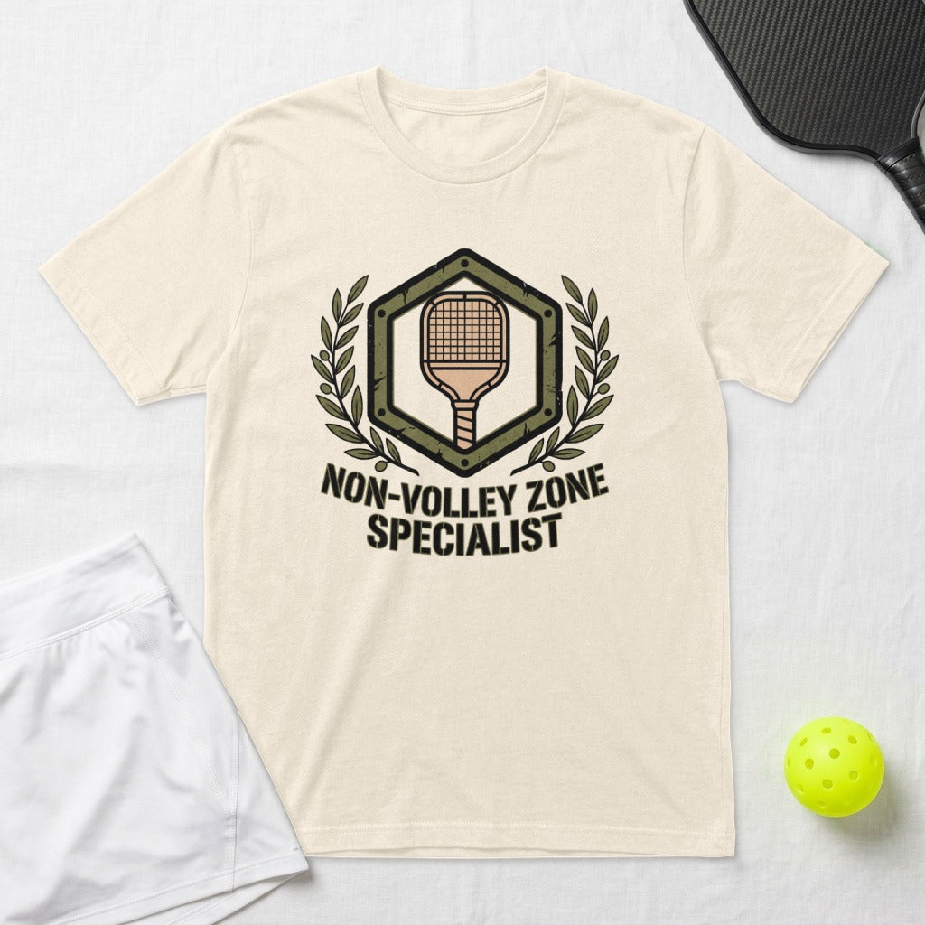 Cream t-shirt with "Non-Volley Zone Specialist" graphic and pickleball equipment.