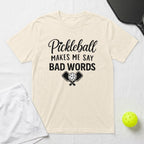Cream t-shirt with "Pickleball Makes Me Say Bad Words" graphic and crossed paddles.